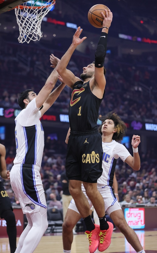 Cleveland Cavaliers guard Max Strus drives to the basket for a score guarded by Orlando Magic center Goga Bitadze during the first half