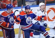 Oilers' Zach Hyman, middle, celebrates his goal against the Panthers with Ryan Nugent-Hopkins, left, as Panthers' Gustav Forsling skates past during the second period of Game 6 of the Stanley Cup Final on Friday in Edmonton, Alberta.