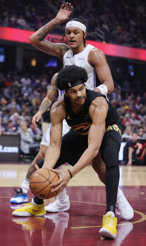 Cleveland Cavaliers center Jarrett Allen secures a loose ball under the rim defended by Orlando Magic forward Paolo Banchero in the first half
