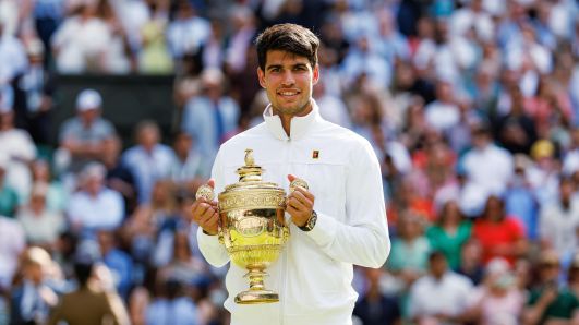 LONDON, ENGLAND - JULY 14: Carlos Alcaraz of Spain celebrates with the Gentleman's Singles Trophy after his victory over Novak Djokovic of Serbia in the final of the men's singles, during day fourteen of The Championships Wimbledon 2024 at All England Lawn Tennis and Croquet Club on July 14, 2024 in London, England. (Photo by Frey/TPN/Getty Images)