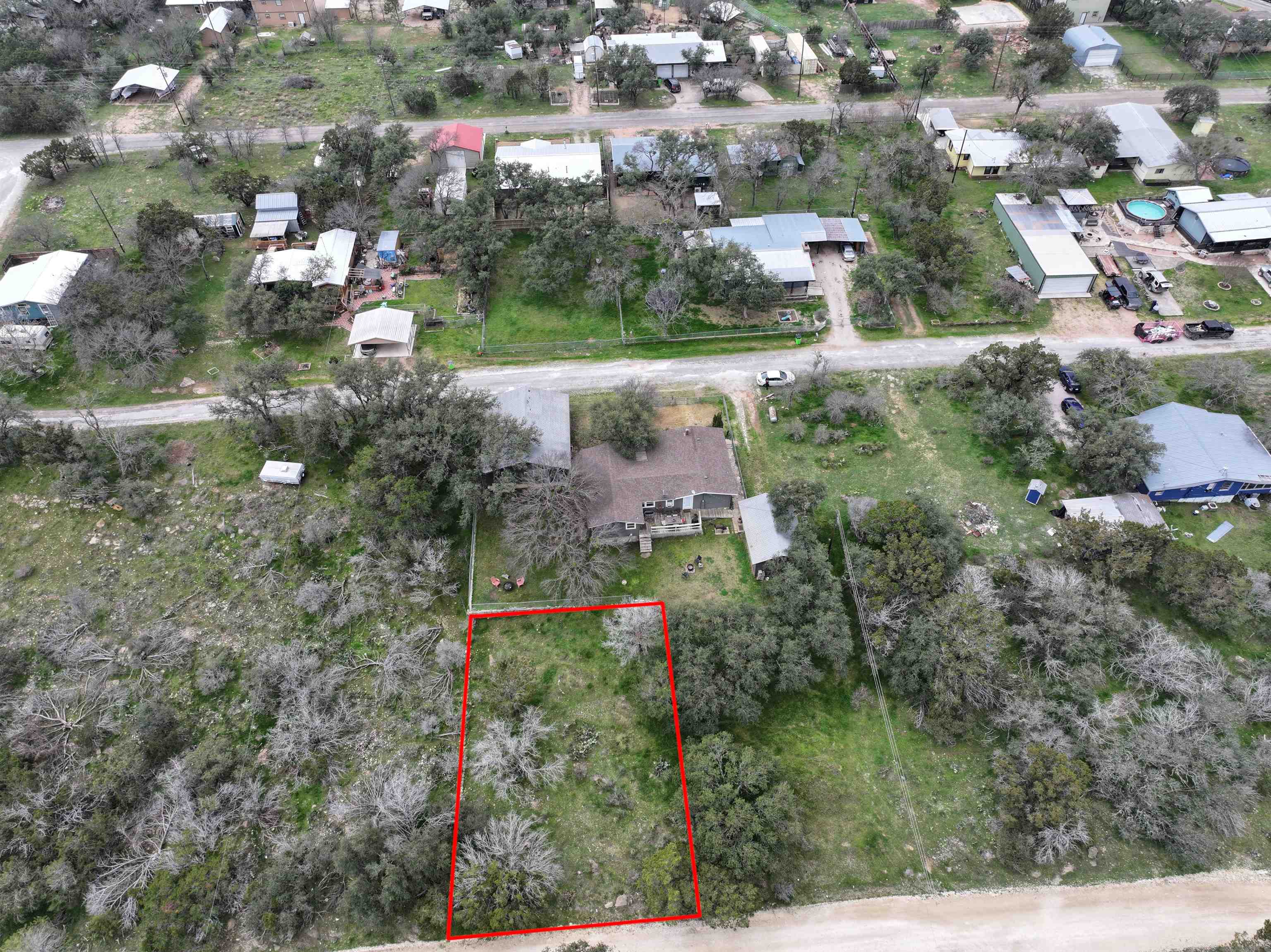 an aerial view of residential houses with outdoor space and street view