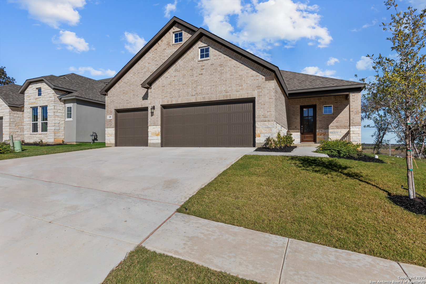 a front view of a house with a yard and garage