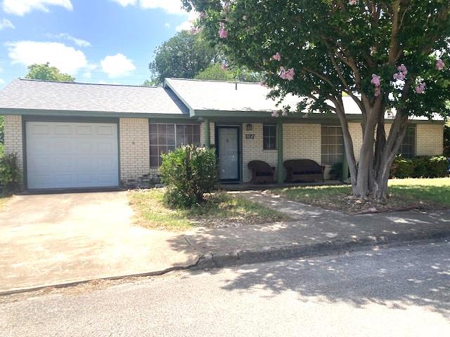 a view of a house with a yard and tree