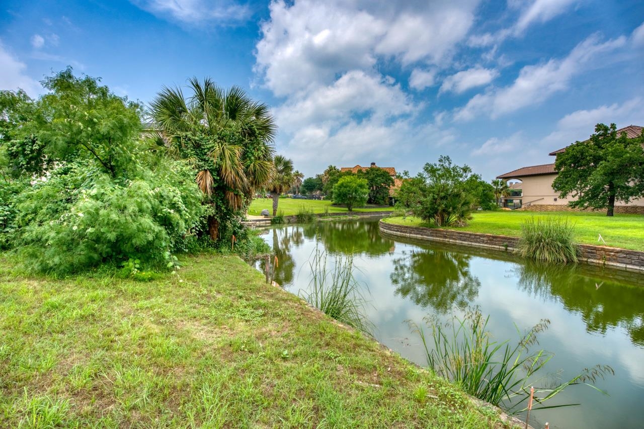 a view of a lake with a house in the background