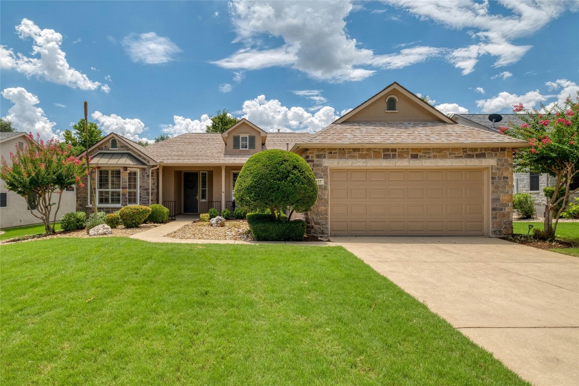 a front view of a house with a yard and garage