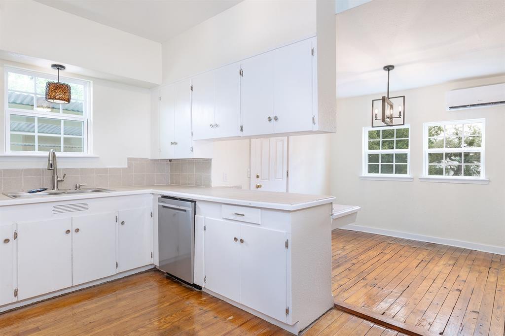 a kitchen with a sink window and cabinets