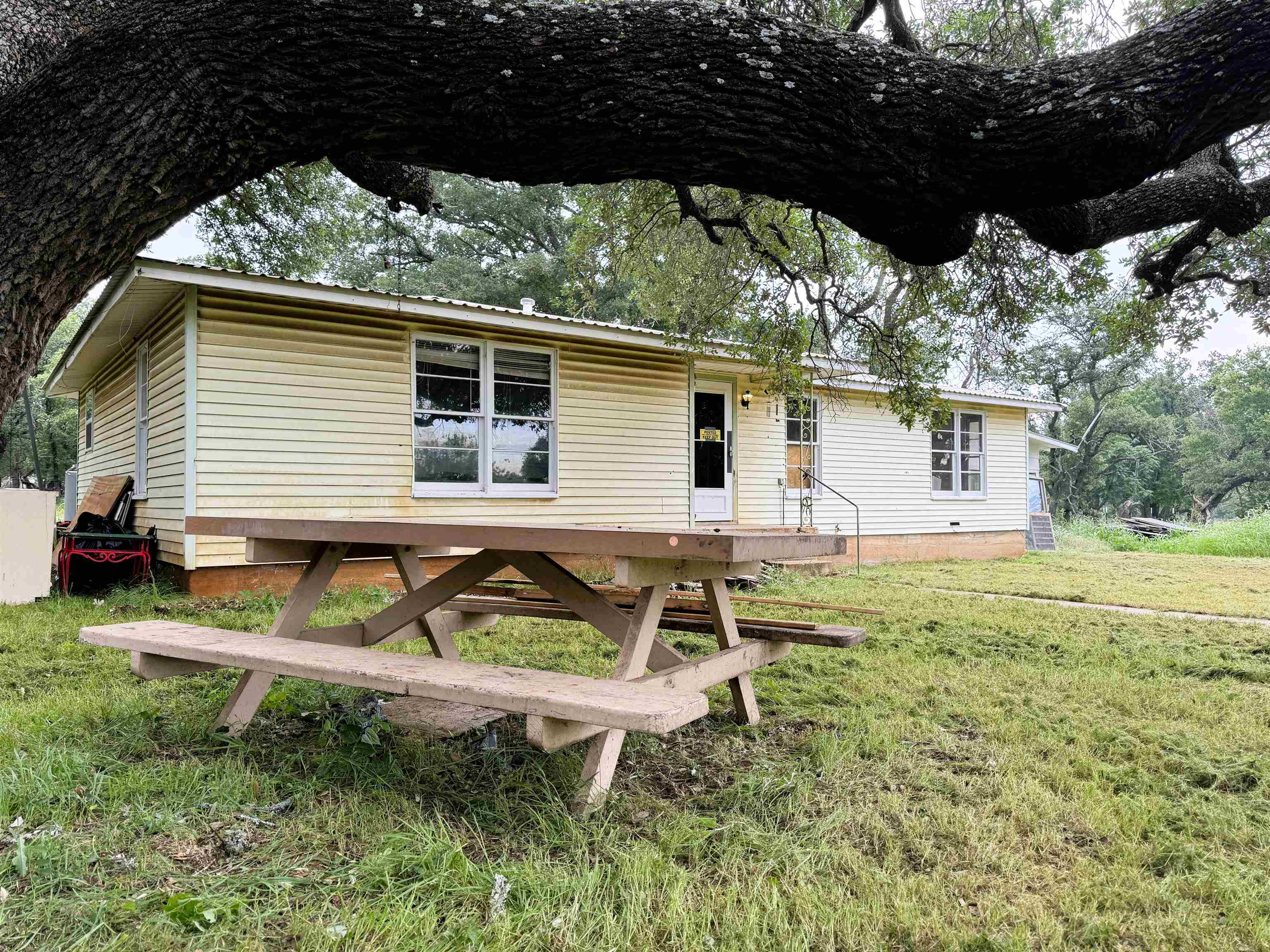 a backyard of a house with table and chairs