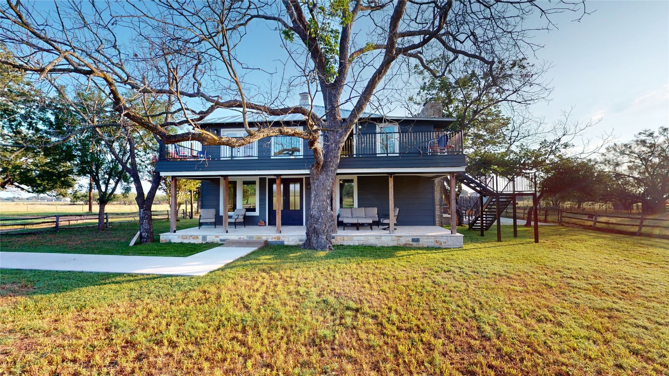 a view of a house with garden and sitting area