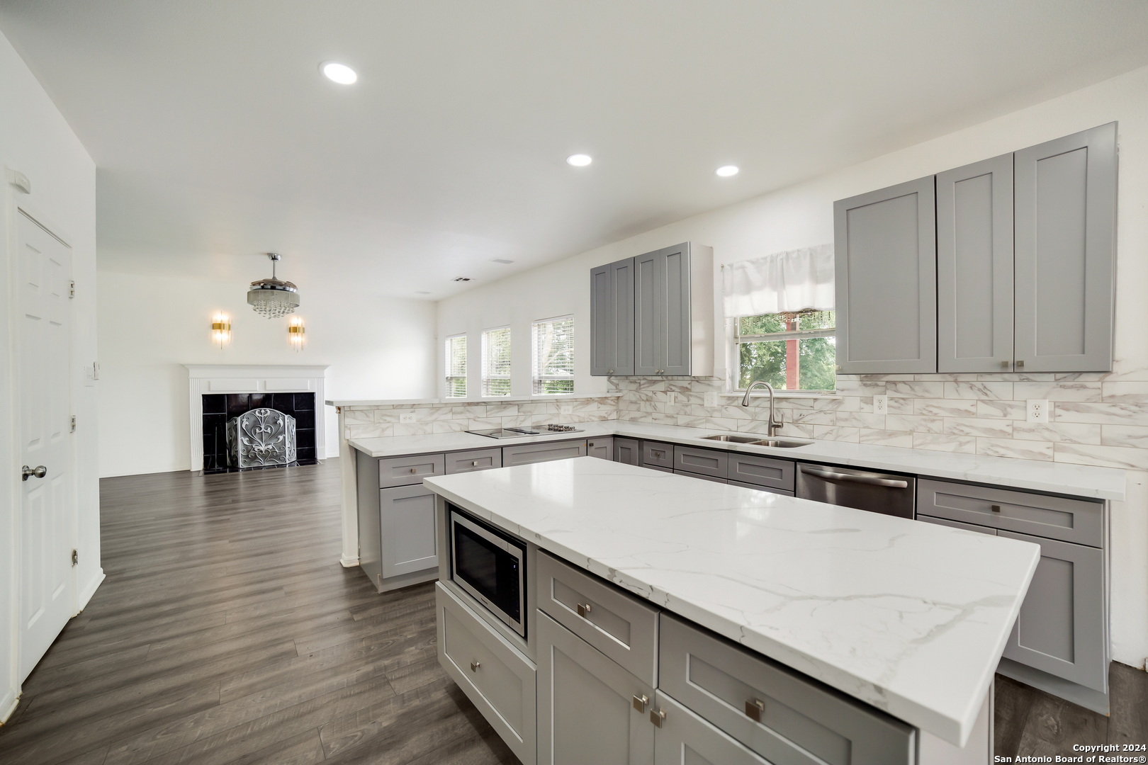 a large kitchen with granite countertop a stove and a sink