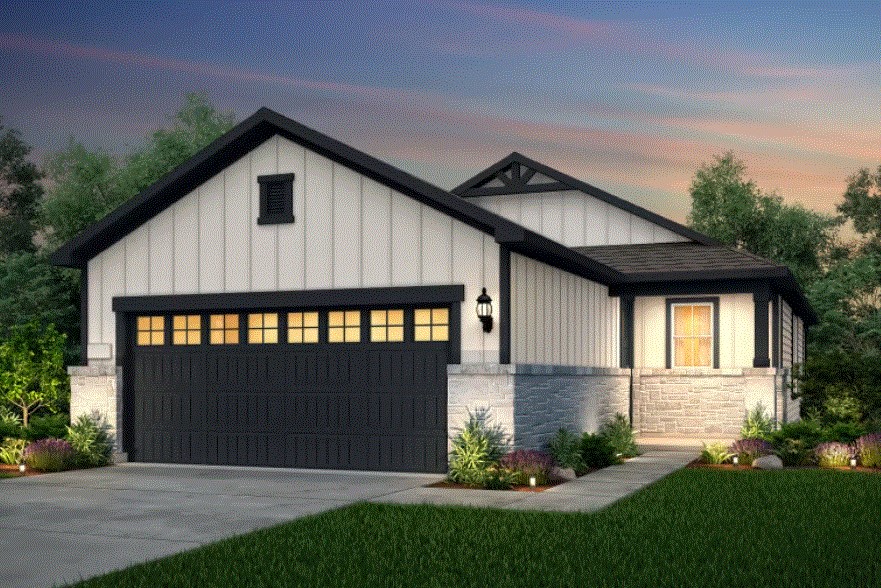 a front view of a house with a garden and garage