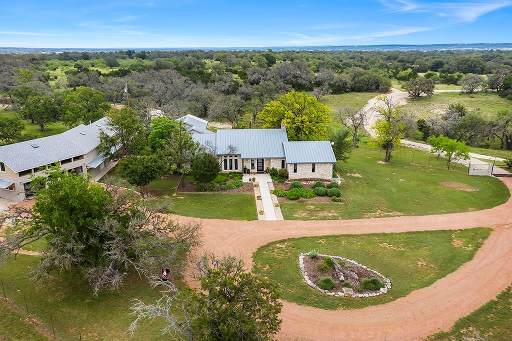 an aerial view of residential houses with outdoor space and swimming pool