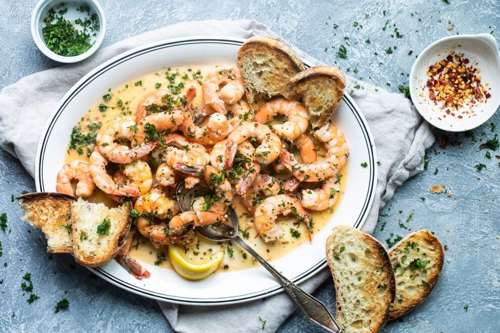 Shrimp scampi on a white platter.