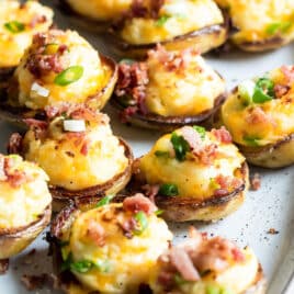 Mini twice baked potato skins on a platter.