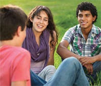 Young people talking while sitting in a circle