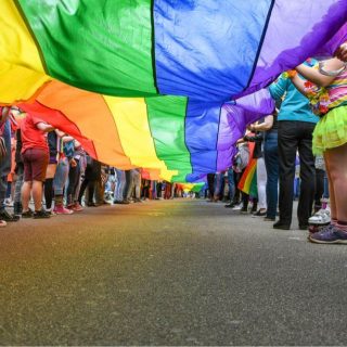 lgbtq+ group holding a rainbow flag