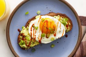 overhead shot of avocado toast with a fried egg on top