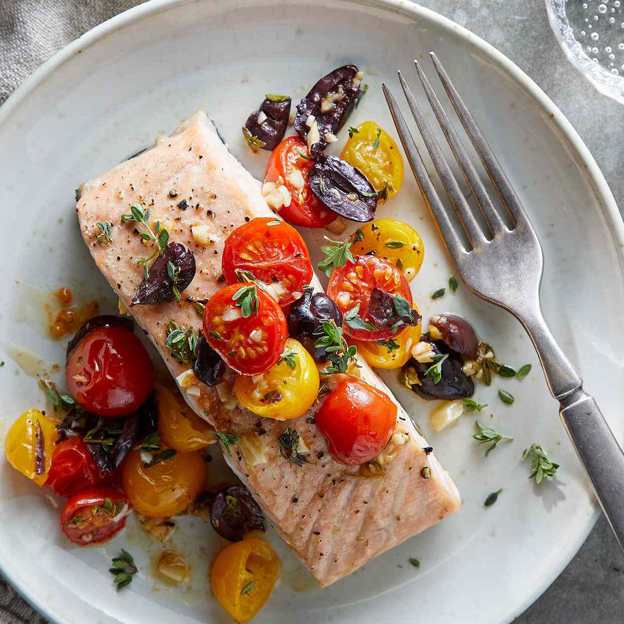 Salmon with Tomatoes and Olives recipe on a white plate