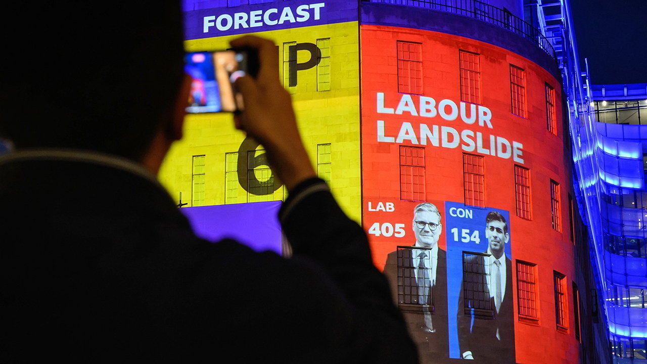 Predicted seat totals in the 2024 General Election are displayed onto the exterior of BBC Broadcasting House.