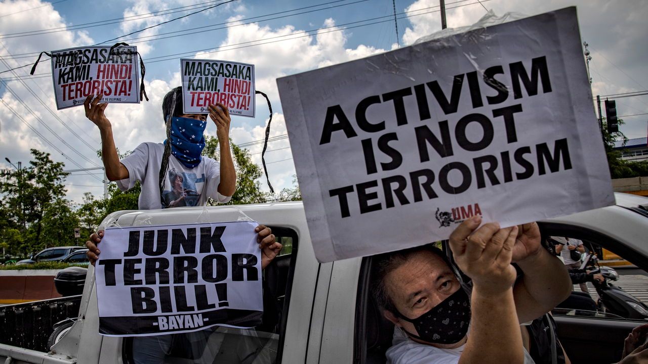 Demonstrators hold up placards as they protest against an anti-terror bill outside the Philippine congress in Quezon city, Metro Manila, Philippines, June 3rd 2020