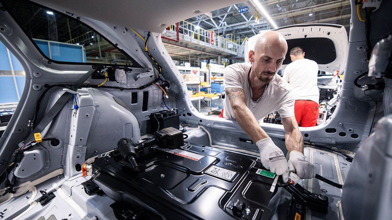 Workers install an electric battery on an assembly line in Slovakia