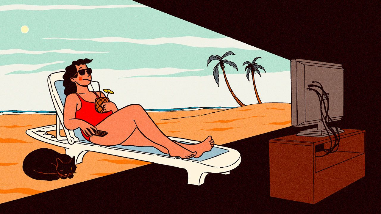 A woman relaxing in a deck chair on a beach watching TV. The light from the TV is illuminating the background scenery