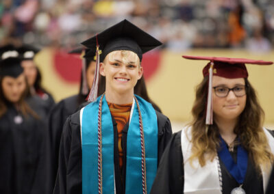 a student smiles during the commencement ceremony procession