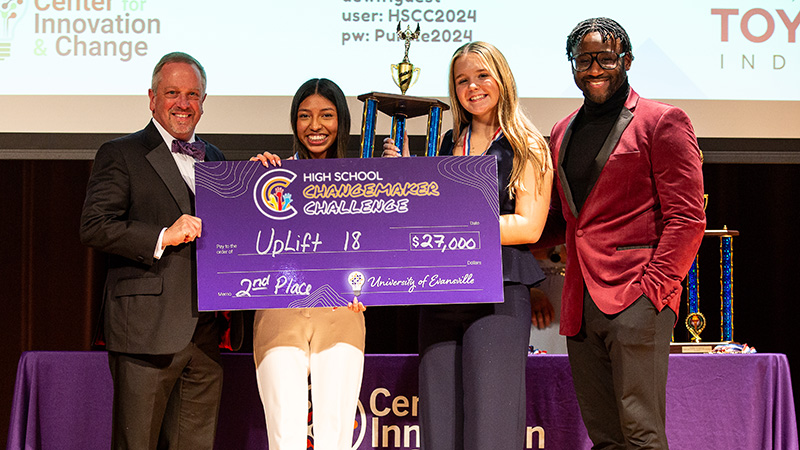 Second place winners holding check