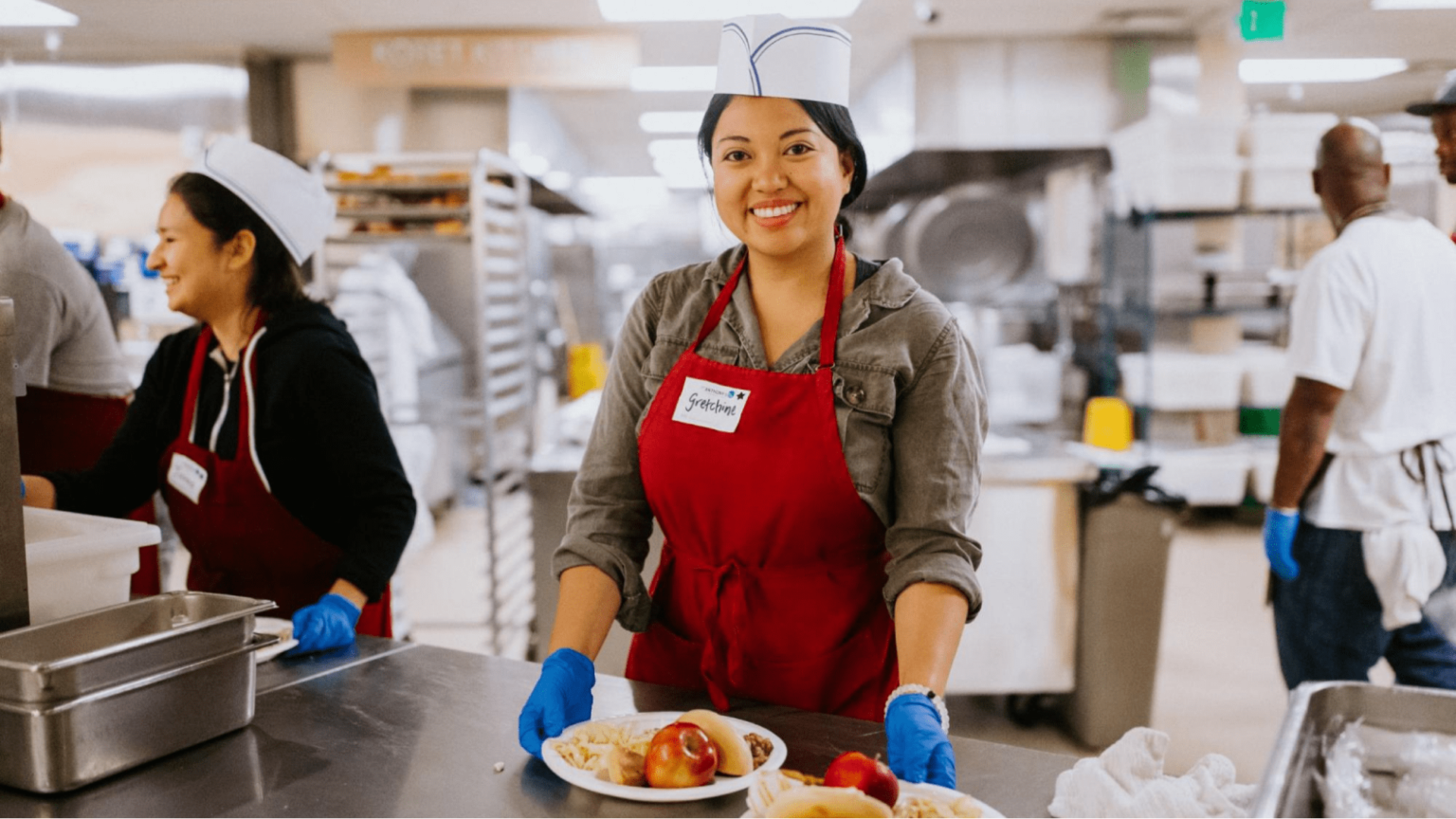 Volunteer plates up food at charity event