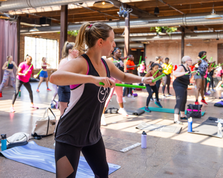 Attendees participate in a class at a Strength In The City event