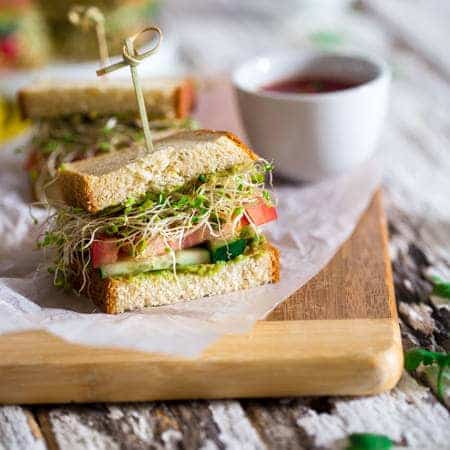 Mexican Avocado and Veggie Gluten Free Sandwiches - Slices of bread are layered with a creamy Mexican avocado spread, spicy sprouts, tomatoes and cucumbers. They're an easy, healthy meatless lunch option for under 250 calories! | Foodfaithfitness.com | @FoodFaithFit