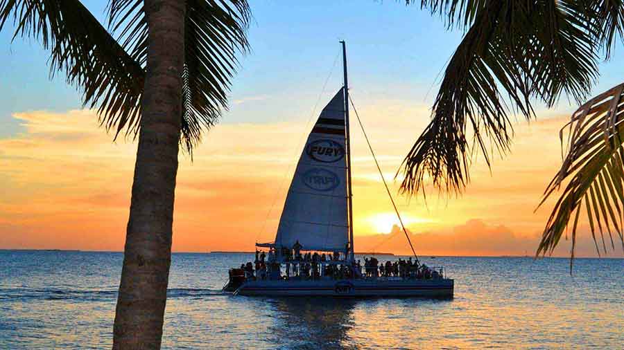 Image of Fury catamaran sailing into Key West sunset