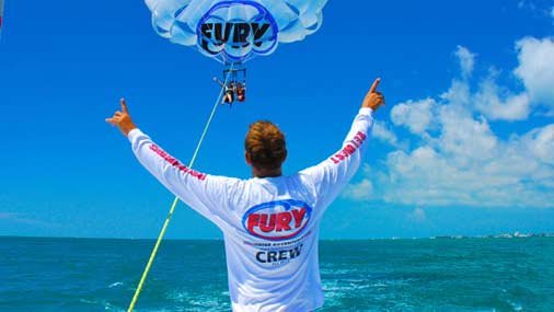 Man standing in front of people on a parasail