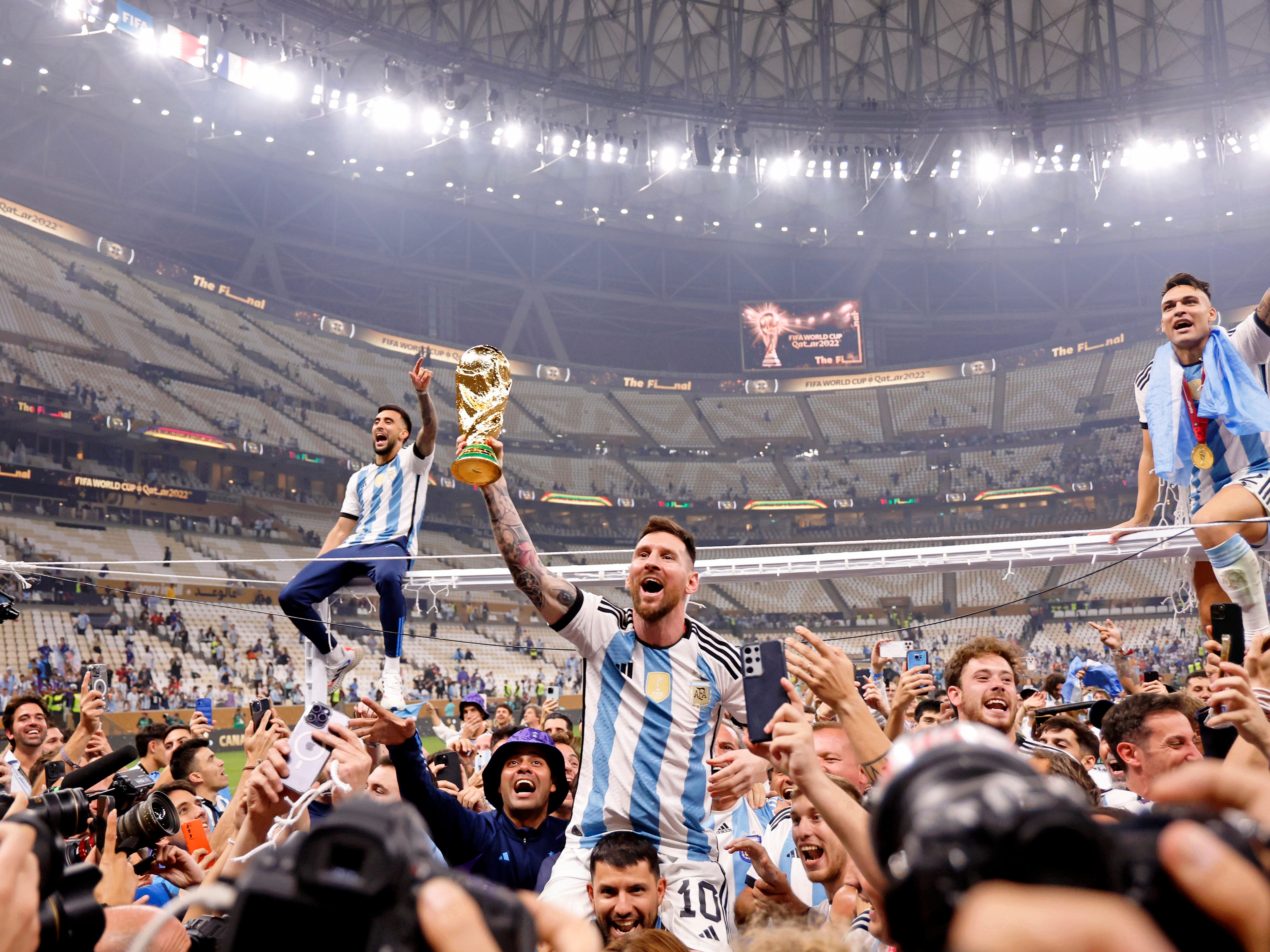 Argentina players carry Lionel Messi on their shoulders after winning the 2022 World Cup final against France at Lusail Stadium.