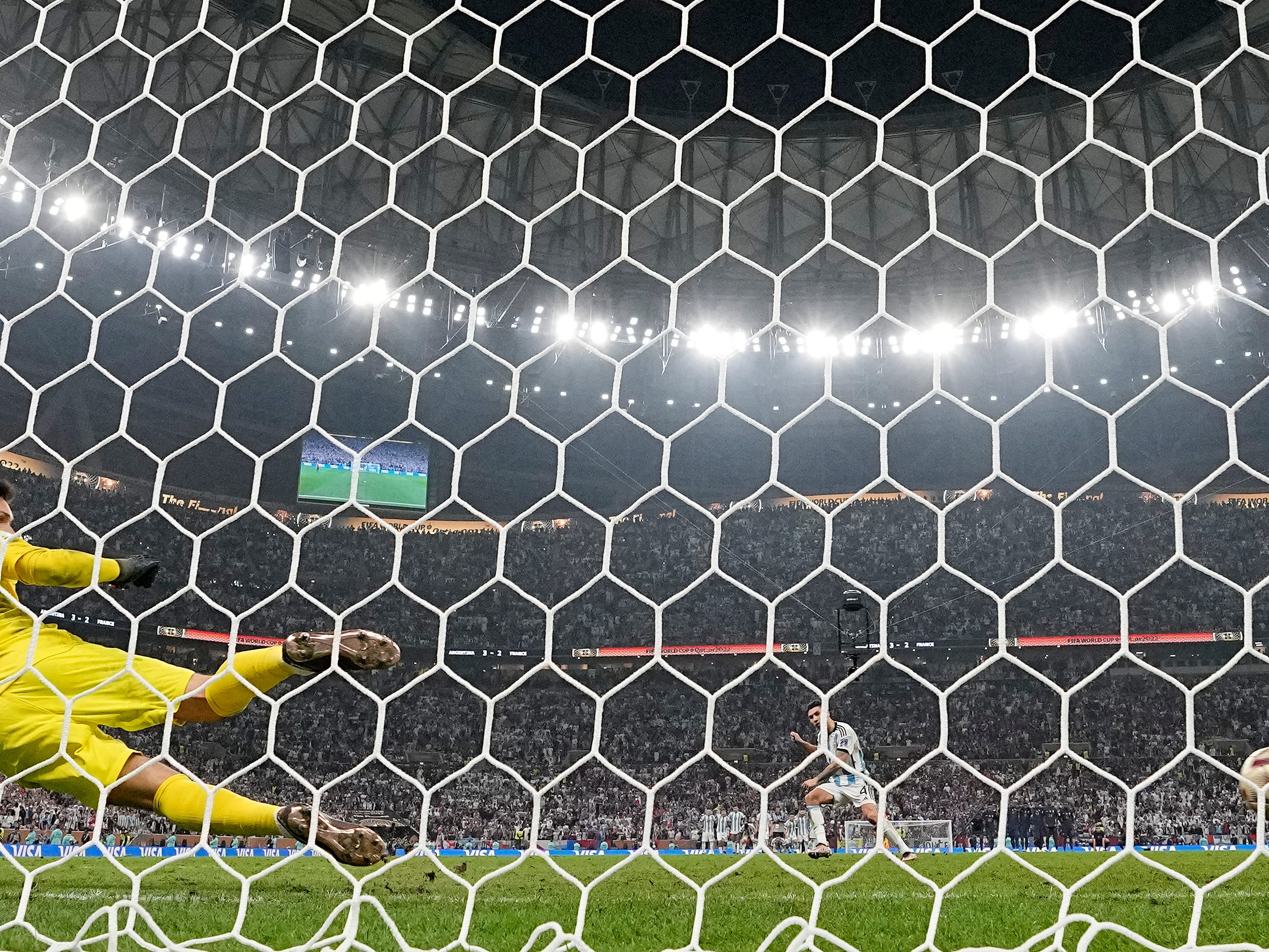 Argentina's Gonzalo Montiel scores the winning penalty past France goalkeeper Hugo Lloris to win a shootout.