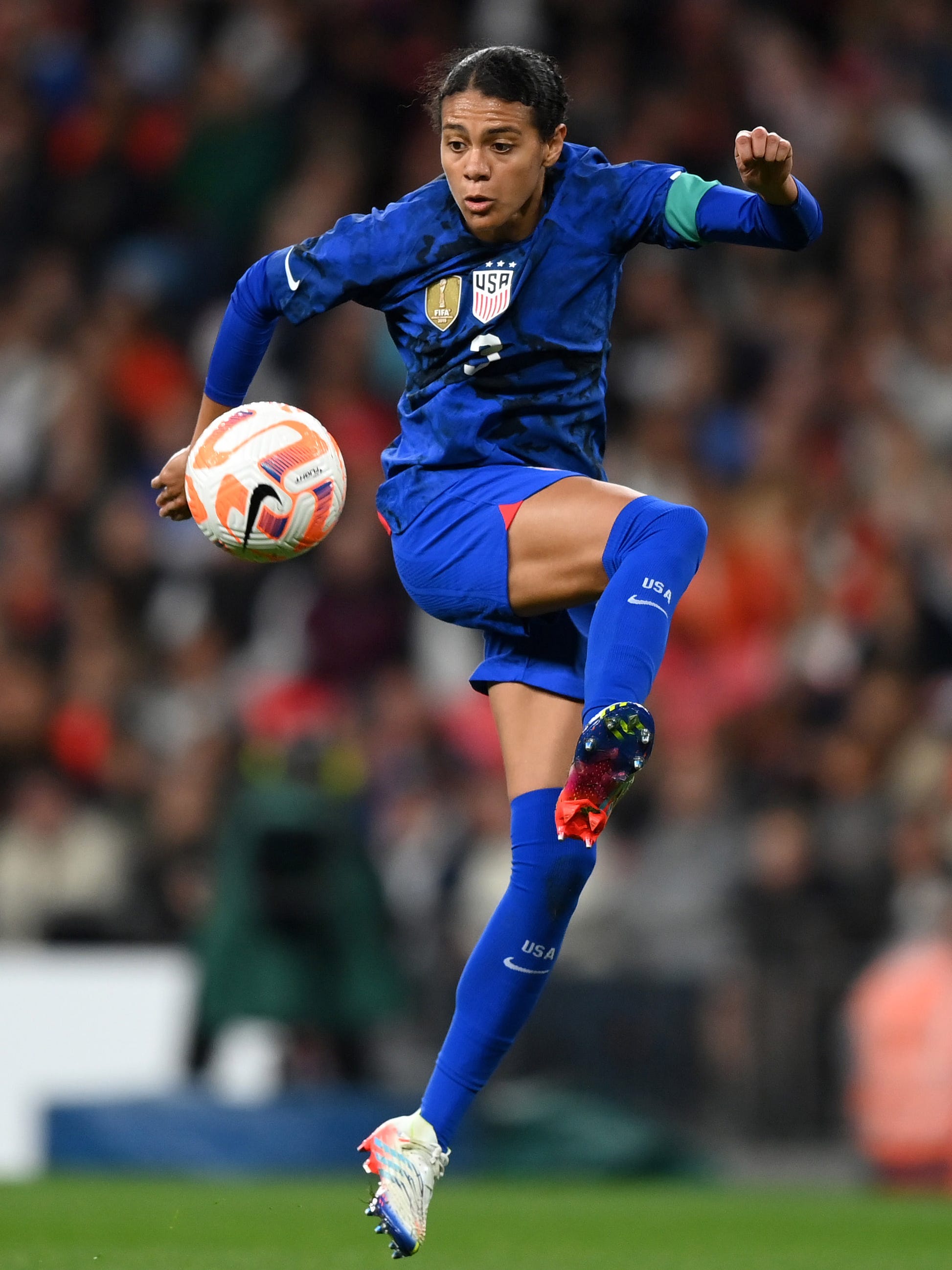 An action image of Alana Cook playing soccer.