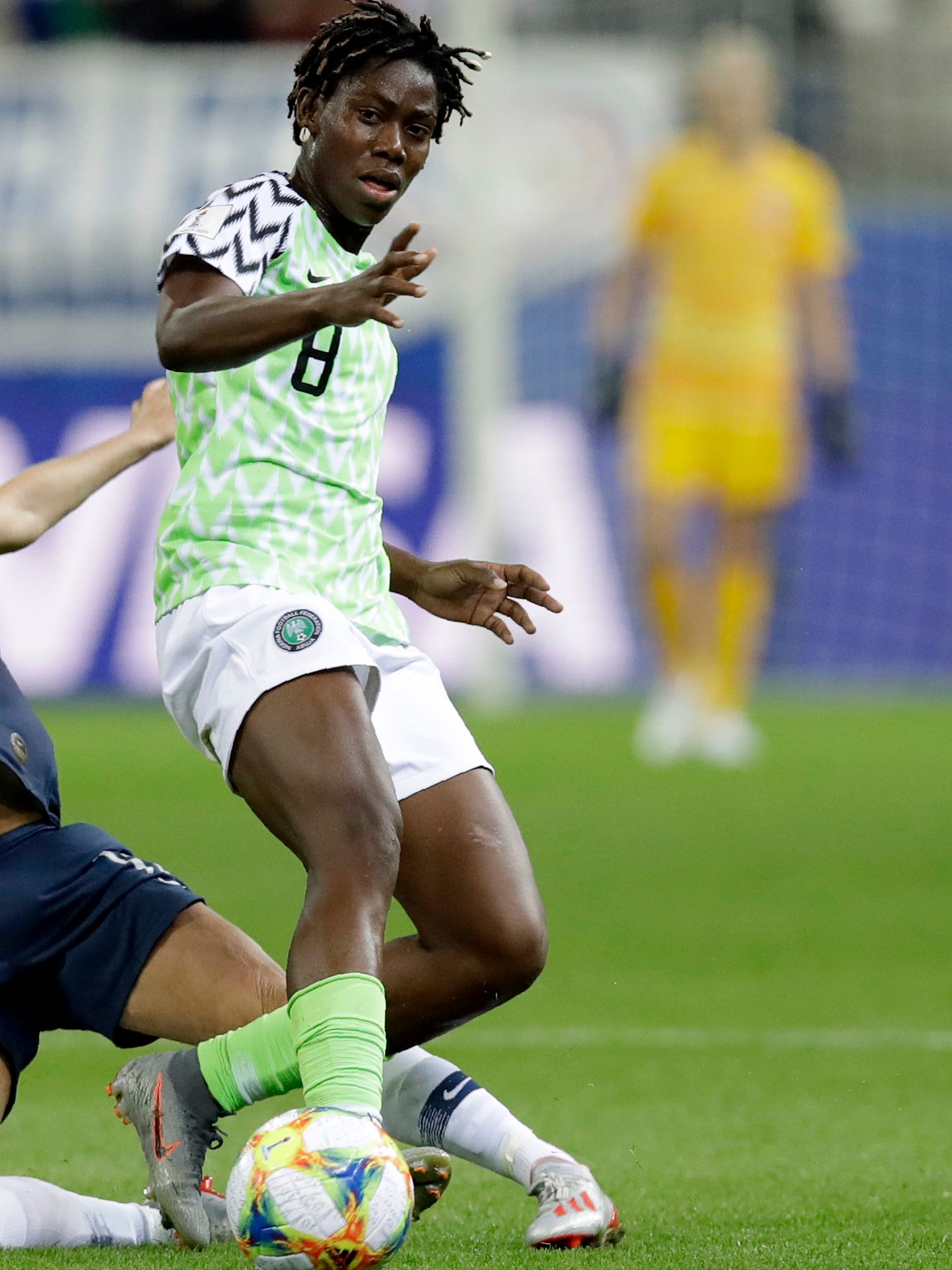 An action image of Asisat Oshoala playing soccer.