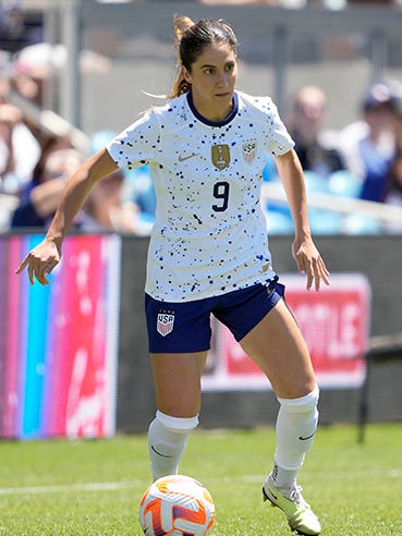 An action image of Savannah DeMelo playing soccer.