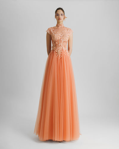 A fully embellished floral see-through corset evening dress in peach color with a high-collar and flared tulle skirt.