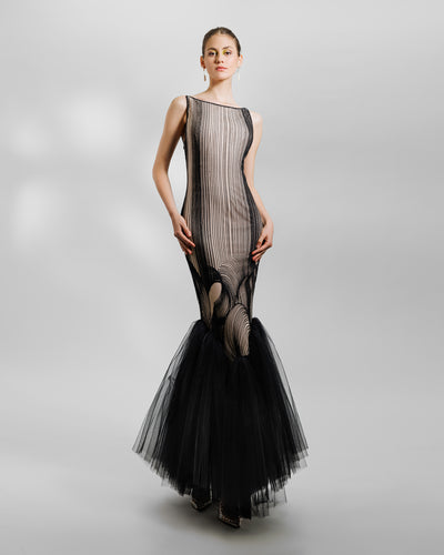 An embroidered pattern black slim-cut dress with a gathered tulle hemline.