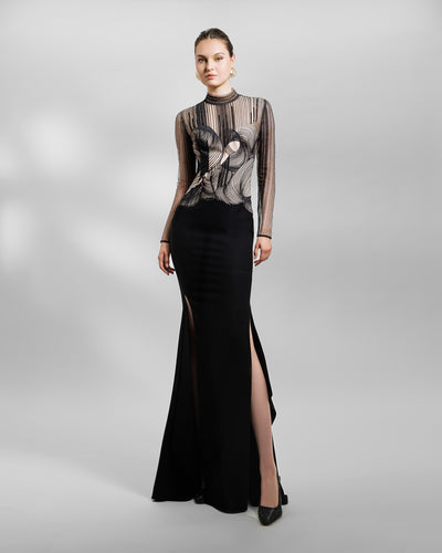 A Long-sleeve slim-cut black evening dress featuring an embroidered upper part lace slits on the sides.