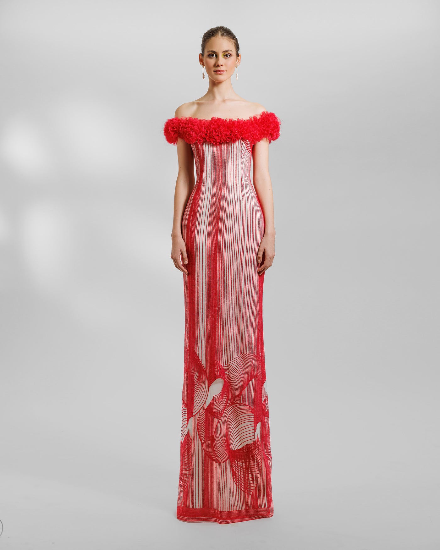 An off-the-shoulders slim-cut red evening dress with rushed organza on the neckline and an open slit at the back.