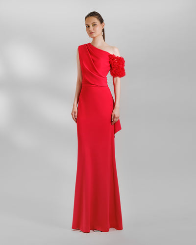 A One-shoulder red evening dress with a rushed organza short sleeve, draped open back, and a ruffled slit.
