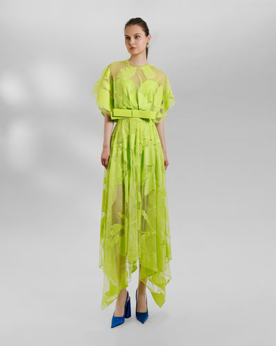 A patterned lace midi dress with a bow design on the waist and an asymmetrical hemline, all in lime color.