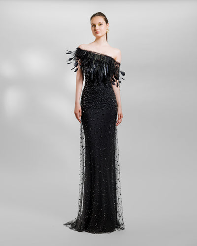 An asymmetrical feather neckline fully beaded black evening dress.