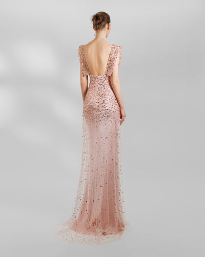 The back of a fully beaded pink slim straight evening dress featuring structured shoulders and an open back.