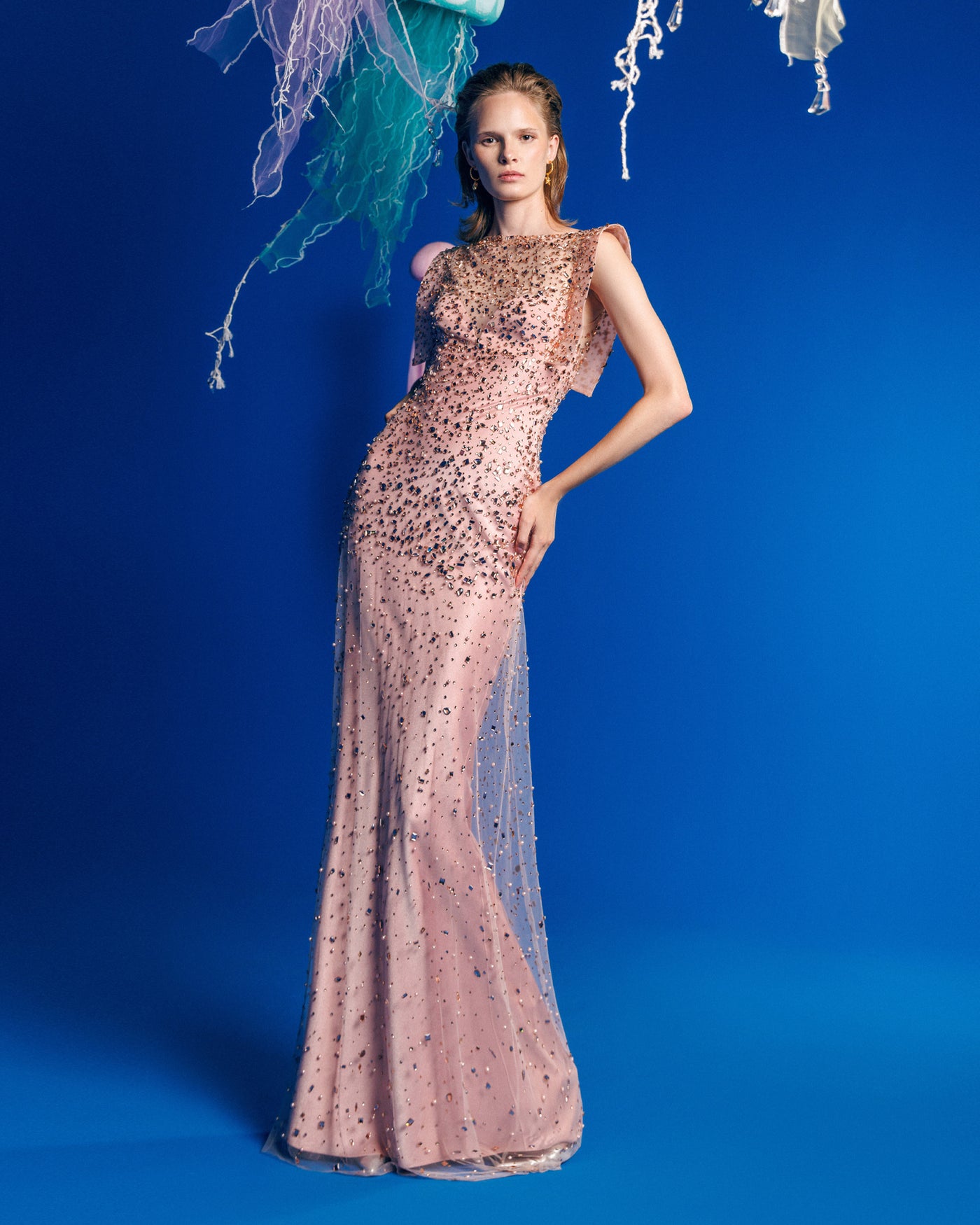 A fully beaded pink slim straight evening dress featuring structured shoulders.