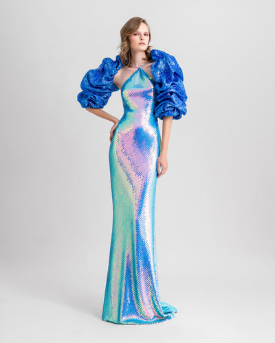 A halter-neck slim-cut evening dress fully sequined in blue color, paired with a draped bolero.