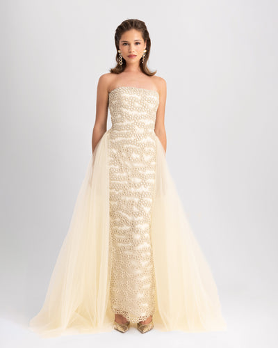 A strapless, fully embroidered slim-cut evening dress in cream, with a flowy tulle tail.