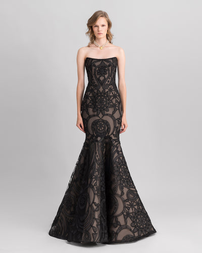 A strapless mermaid-cut lace black evening dress with a flared tail.