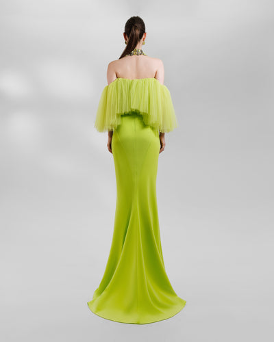 The back of an evening look in lime color featuring an off-the-shoulders tulle top paired with a slim-cut skirt. The look is completed with a matching beaded collar necklace.